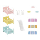 Triple bunk beds set in pastel colors with two ladders, a slide, and decorative mats for dollhouse play.