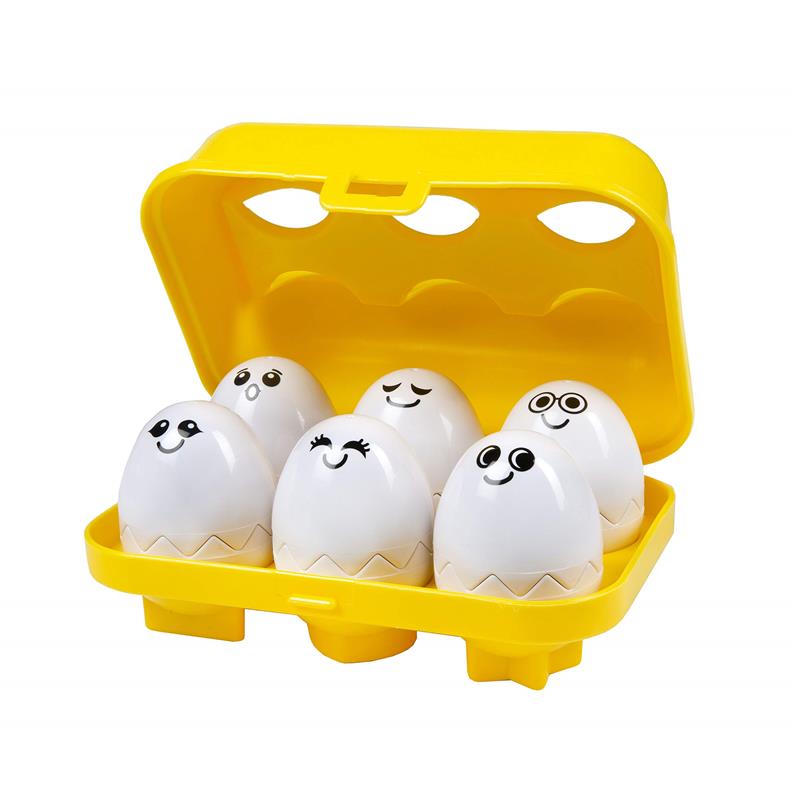 Six smiling, cartoonish eggs in a yellow carrying case, designed as a baby match-up toy with lights and music.
