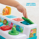 Colorful toy with animal shapes to learn colors and numbers; a child’s hand interacts with the green lid.