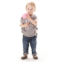 Toddler holding a pink baby doll in an Ergobaby Original Baby Doll Carrier, Galaxy Grey, featuring star patterns.