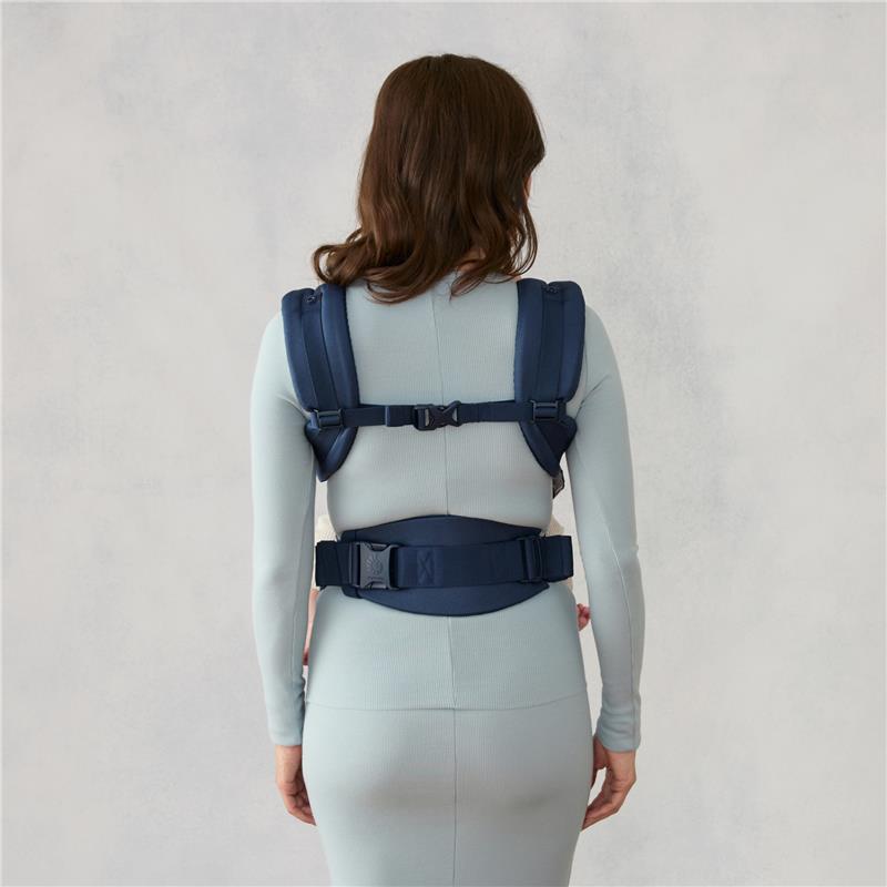Ergobaby Omni Classic Baby Carrier in Midnight Blue worn by a person, showcasing the back and adjustable straps.