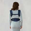 Ergobaby Omni Classic Baby Carrier in Midnight Blue worn by a person, showcasing the back and adjustable straps.