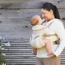 Ergobaby Omni Classic Baby Carrier in Natural Beige, worn by a woman holding her baby, both smiling at each other.