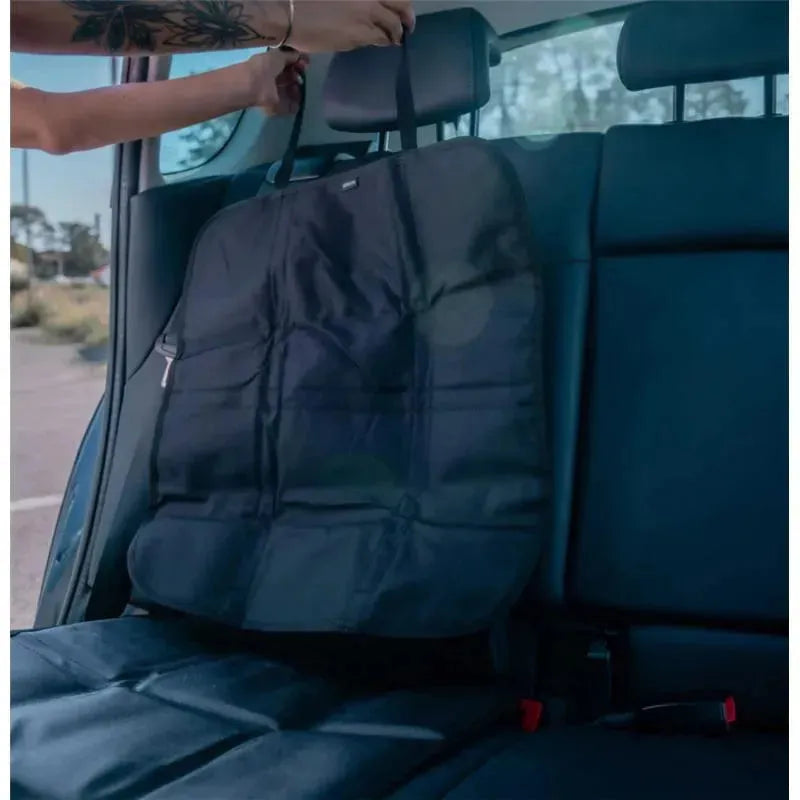 Ezi Seat Protector Premium being attached to a car seat, featuring a durable, black fabric and adjustable straps.
