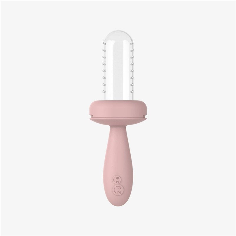 Baby-led weaning feeder in blush color with a transparent top, designed for safe and easy feeding.