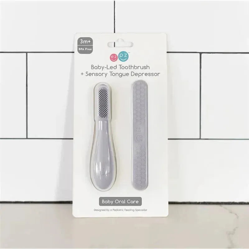 Ezpz Baby-Led Toothbrush and Sensory Tongue Depressor dual pack in pewter, designed for baby oral care, BPA free.