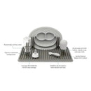 Ezpz Drying Rack in sage color features pegs for bottles and cups, a raised edge to catch water, and a suction base.