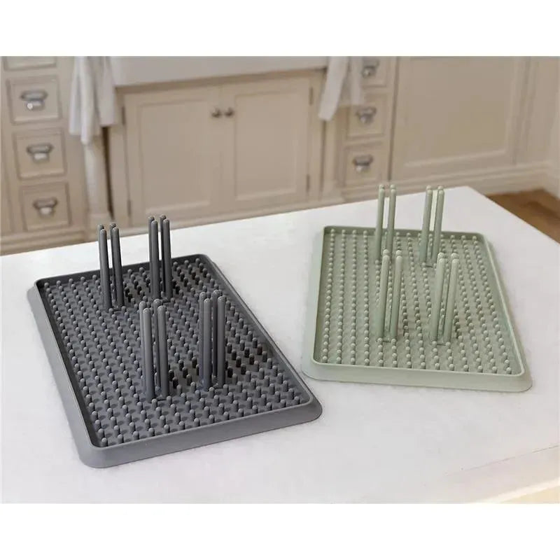 Ezpz Drying Rack in sage and gray, featuring textured surfaces and vertical pegs for drying dishes efficiently.