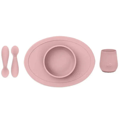 Ezpz First Foods Set in blush color, featuring a suction mat, bowl, two spoons, and a cup, designed for babies.