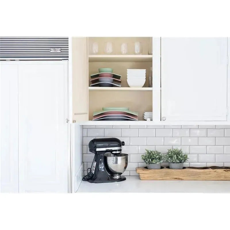 Blush Ezpz Happy Mat displayed in a modern kitchen setting, featuring a black stand mixer, clean dishes, and decorative plants.