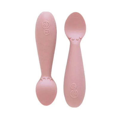 Tiny Spoon in Blush color, designed for babies. Features a soft, ergonomic shape with raised dots for easy grip.