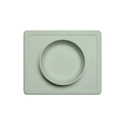Sage-colored ezpz Mini Bowl with a raised outer edge and a circular bowl for easy feeding.