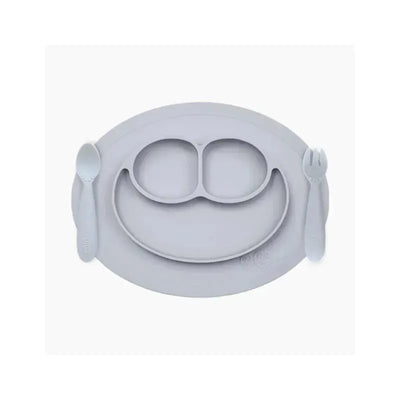 Mini feeding set in pewter color, featuring a divided silicone plate with a smiling face design, a spoon, and a fork.
