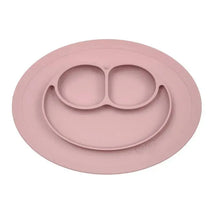 Ezpz Mini Mat in Blush, a silicone feeding mat with three compartments and a smiley face design, ideal for young children.