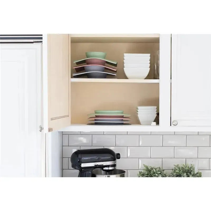 Ezpz Mini Mat in blush color displayed in a kitchen cabinet with colorful plates and bowls neatly arranged.