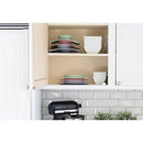 Ezpz Mini Mat in blush color displayed in a kitchen cabinet with colorful plates and bowls neatly arranged.