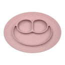 Ezpz Mini Mat in Blush, a silicone feeding mat with three compartments and a smiley face design, ideal for young children.