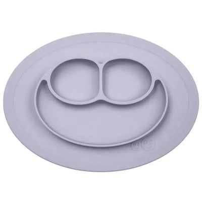 Silicone feeding mat in pewter color with three sections for meals, designed to prevent spills and make mealtime easier.