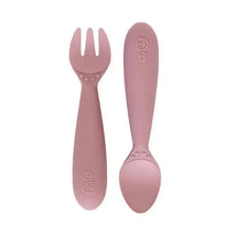 Mini utensils set in blush color, featuring a fork with three prongs and a spoon, designed for young children.