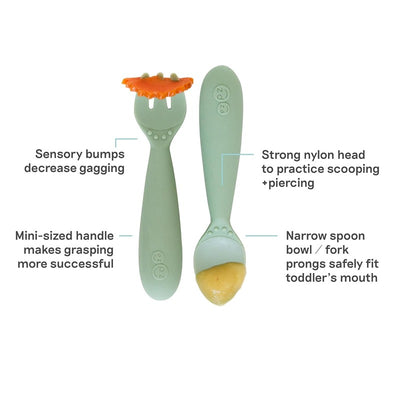 Mini utensils in sage green, designed for toddlers; features a fork and spoon with sensory bumps for easier grasping.
