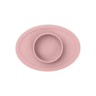 Silicone bowl in blush color designed for children, featuring a raised edge and a central food compartment.