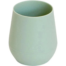 Sage-colored silicone cup designed for easy gripping, featuring a rounded shape and subtle branding on the base.