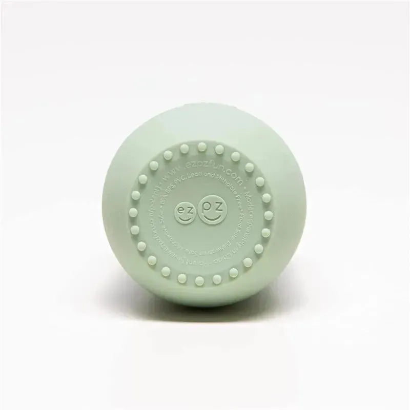 Sage-colored Ezpz Tiny Cup featuring a smooth exterior and textured non-slip base for easy grip.