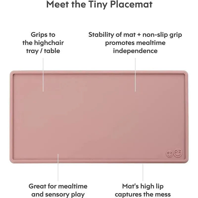 Tiny placemat in blush color, featuring a non-slip grip, high lip to catch messes, promotes mealtime independence, suitable for sensory play.