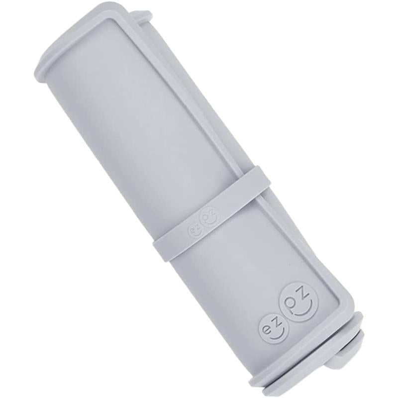 Ezpz Tiny Placemat in pewter, rolled up with a band, designed to keep messes contained during mealtime.