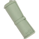 Ezpz Tiny Placemat in sage color, rolled and secured with a band, featuring the brand logo on one end.