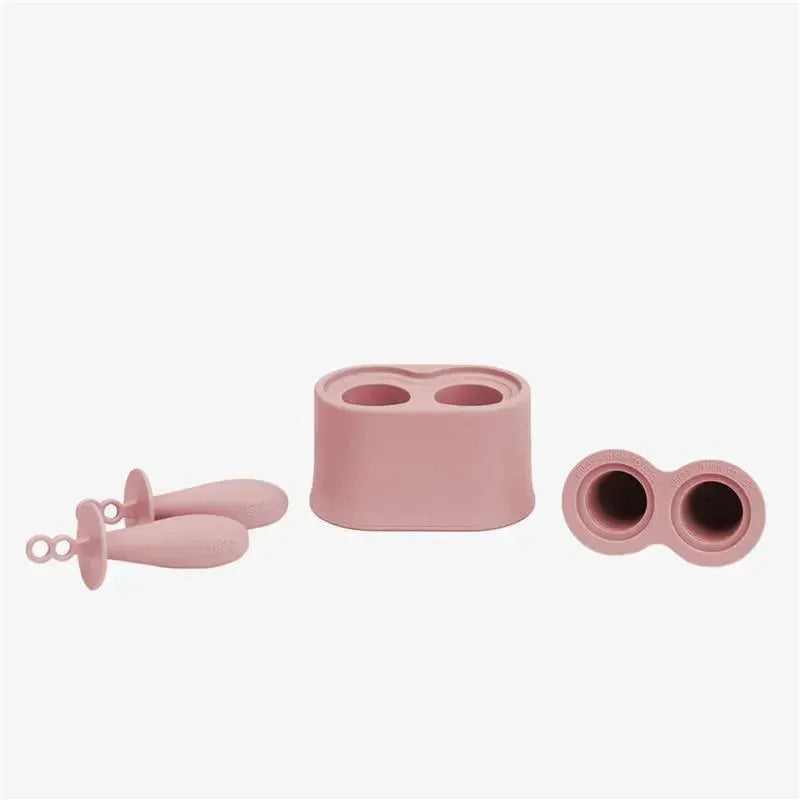Tiny popsicle mold set in pink blush with two molds and two matching wands for creating homemade popsicles.
