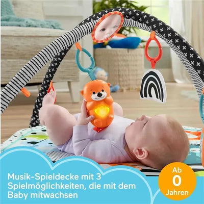 Fisher Price 3-in-1 Music, Glow and Grow Gym Play Mat with baby reaching for a glowing bear toy and hanging accessories.