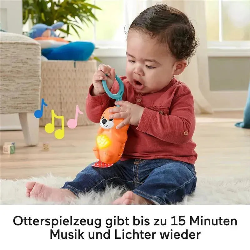 Baby playing with a Fisher Price colorful otter toy that plays music and lights up for 15 minutes, surrounded by a bright room.