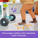 Fisher Price 4-in-1 Snack Cart Walker with gray wheels and toddler using it; encourages walking with music and sounds.