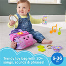 Toddler playing with the Fisher Price Laugh & Learn Purse, featuring a pink toy bag, interactive phone, and colorful accessories.