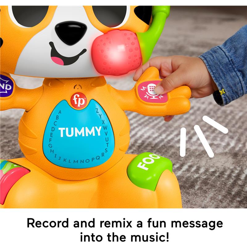 Colorful Fisher Price Bop & Groove Tiger toy with buttons on its paws; a child interacts with it, featuring music and lights.