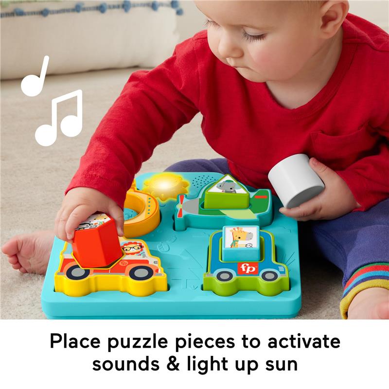 Baby interacts with the Fisher Price sorting toy, placing colorful puzzle pieces to activate sounds and lights.
