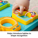 Brightly colored Fisher Price baby sorting toy with shape puzzles, featuring a child’s hand placing a shape.