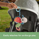 Plush turtle toy with a teether, easily attaches to stroller for on-the-go play; features bright colors and textured elements.