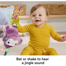 Baby playing with the Fisher Price Purple Monkey plush toy, which jingle sounds when shaken or batted.