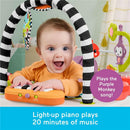 Baby joyfully interacts with a Fisher-Price 2-in-1 Purple Monkey Activity Center featuring a light-up piano.