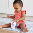 Toddler in a pink outfit plays with a Fisher Price Laugh & Learn Coffee Mug toy featuring lights and sounds.