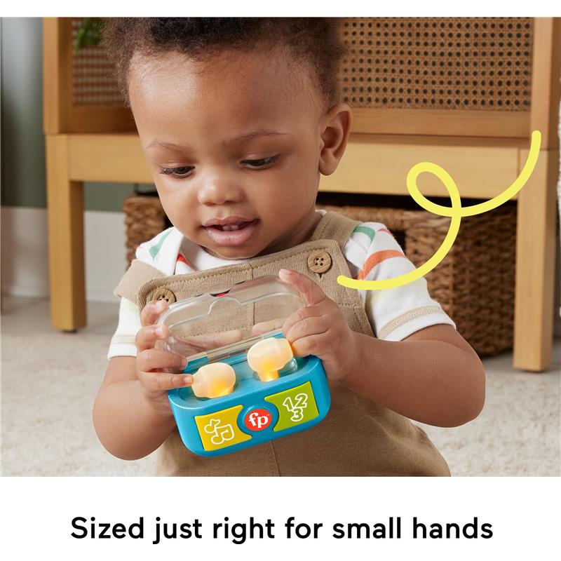 Toddler playing with Fisher Price Laugh & Learn Play Along Ear Buds, brightly colored with music and light features.