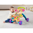Infant playing with the Fisher Price Laugh & Learn Smart Stages Sis Walker featuring buttons and lights for educational fun.