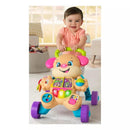 Toddler pushing the Fisher Price Laugh & Learn Smart Stages Sis Walker, displaying colorful buttons and educational features.