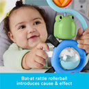 Infant engaged with a Fisher-Price sensory toy featuring a frog and a rattle, promoting cause and effect learning.