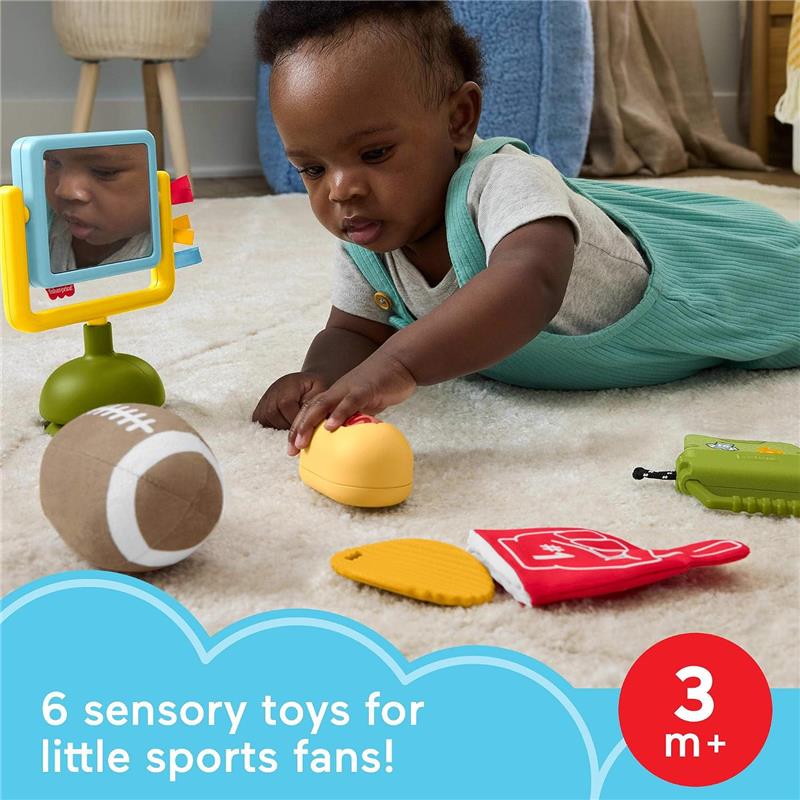 Toddler playing with the Fisher-Price Tiny Tailgater Set, featuring a football, sensory toys, and a colorful mirror.