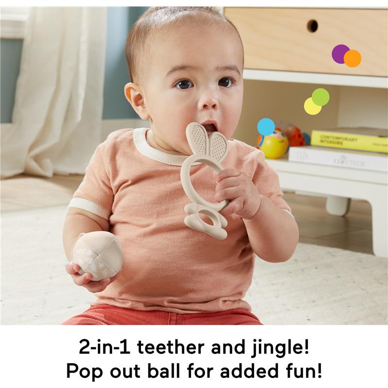 Infant playing with a bunny-shaped teether and holding a pop-out ball, promoting sensory exploration and fun.