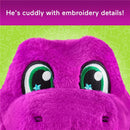 Cuddly purple dinosaur plush toy with large green eyes and embroidered details, set against a playful green background.