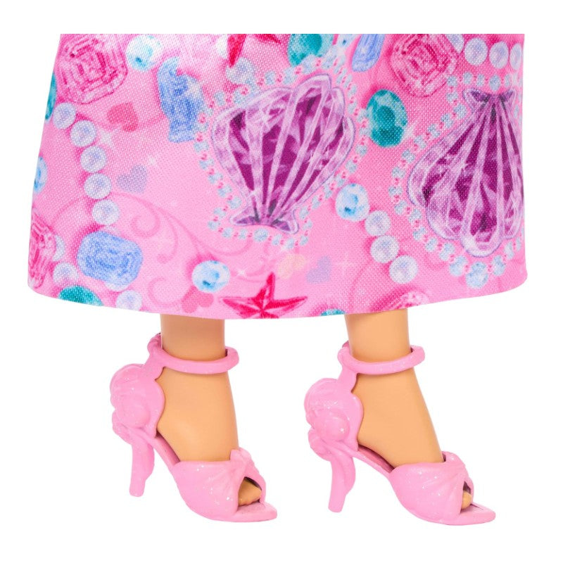 Ariel fashion doll featuring a pink dress with colorful shell patterns and matching pink shell high heels.